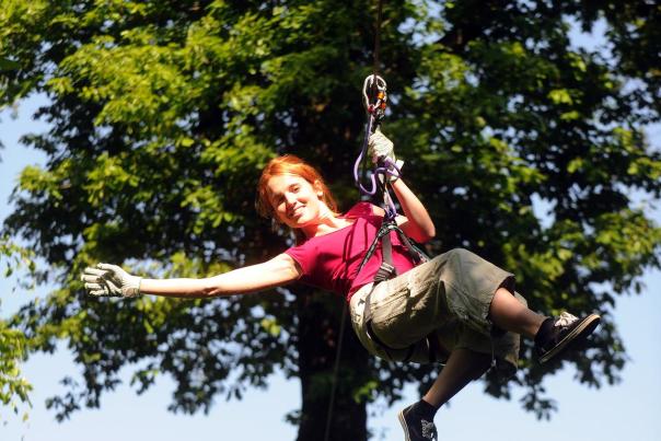 Girl ziplining at treetop quest