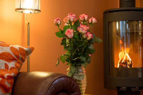 A cosy corner of a cottage with a warming log burner