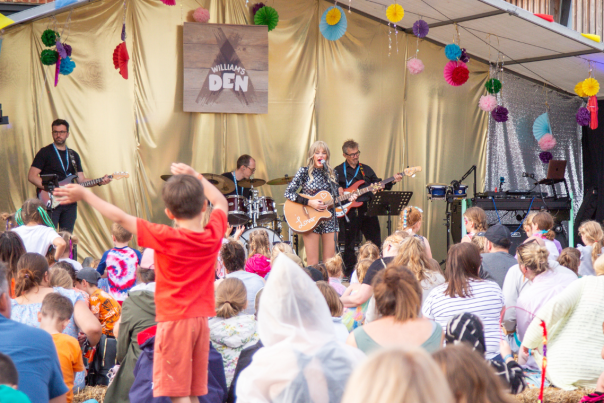 A crowd watching a Taylor Swift tribute act on stage at Den Fest, a summer family festival at William's Den in East Yorkshire.