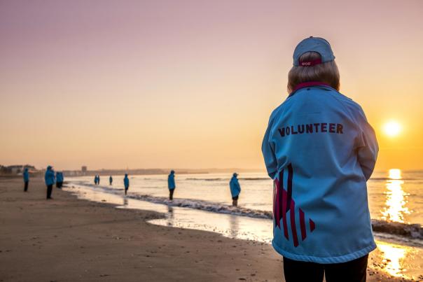 HEY volunteers standing on Bridlington beach on the shoreline