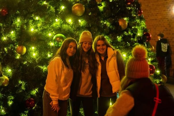 Women taking picture in front of Christmas tree in Downtown Elizabethtown.
