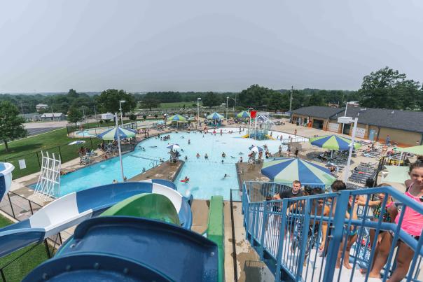 A vibrant outdoor water park in Elizabethtown, KY, filled with people enjoying various water activities.