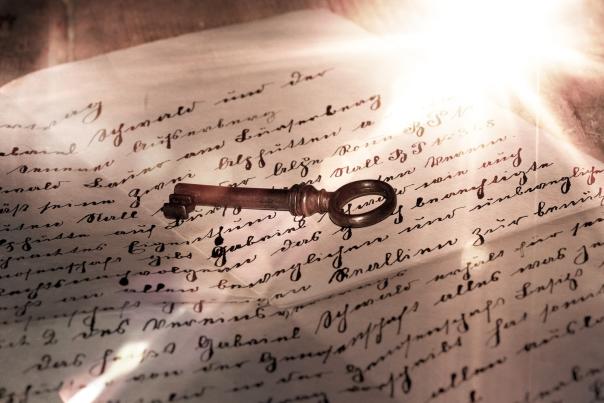 Love Letter written in English cursive with a key on top of it