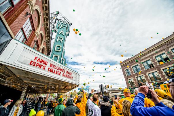 fargo theatre sign with green and yellow balloons and a large crowd of people