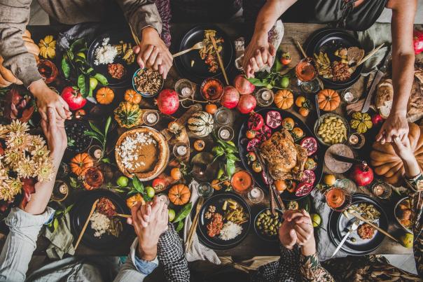 table of group eating thanksgiving dinner