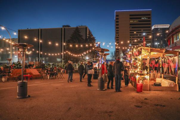 event with people outside during the winter with twinkly lights overhead