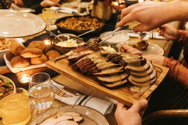 Thanksgiving food spread being passed around the table