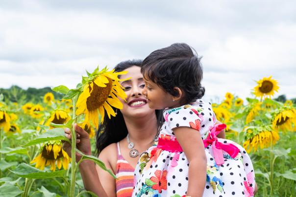 Mother and daughter in the sunflower fields