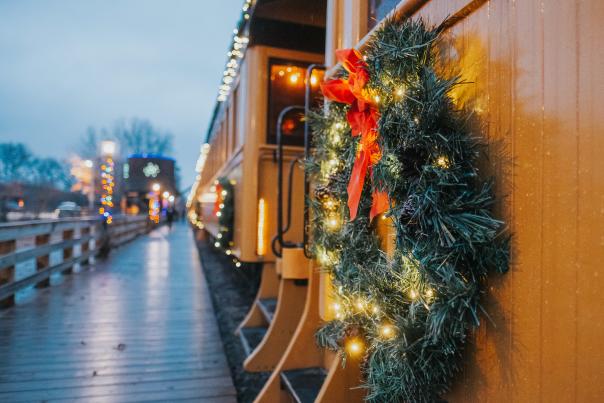 A Christmas wreath on the side of a yellow train car at Crossroads Village and Huckleberry Railroad in Genesee County, Michigan.