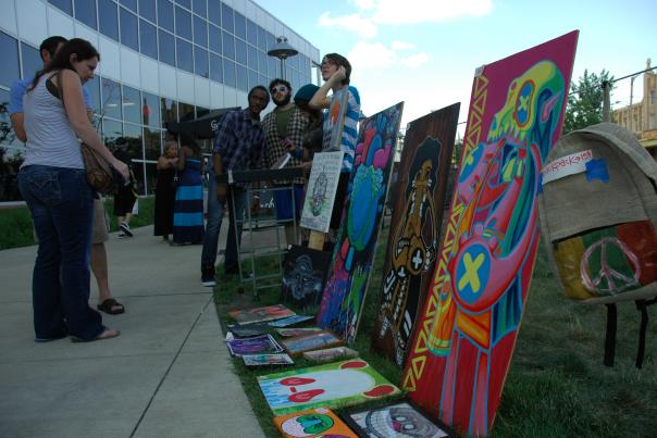 Patrons looking at art in a downtown Flint park during ArtWalk.