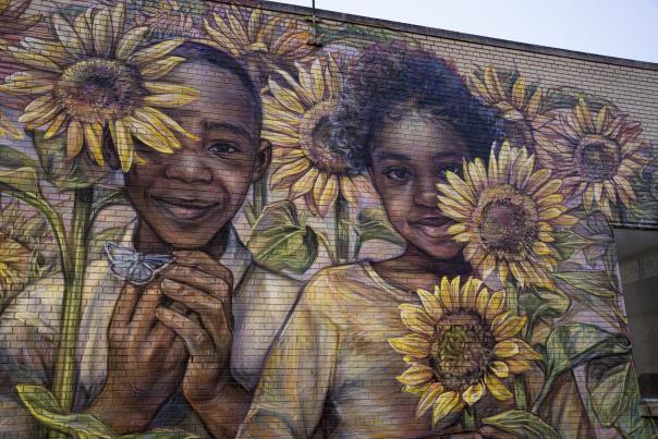 One of the downtown Flint murals. This mural features two Black children peering out from behind sunflowers.