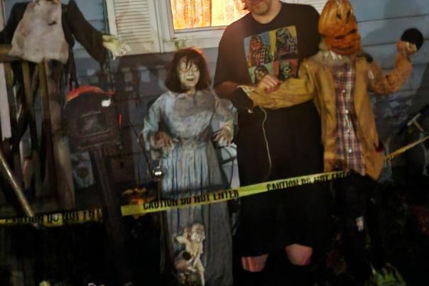 Author Paul Counelis posing among Halloween decorations.