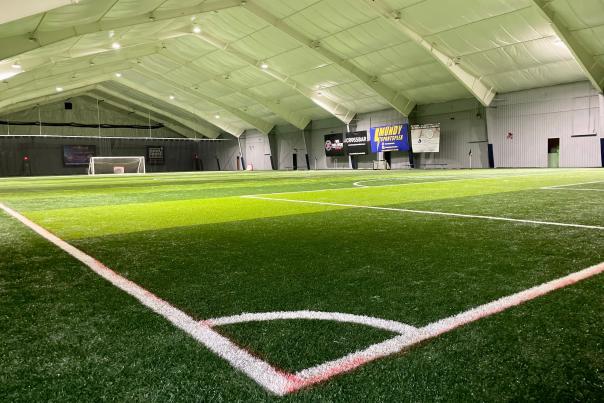 A photo of the Mundy Sports Complex's indoor soccer field looking from the corner of one goal to the opposite goal.