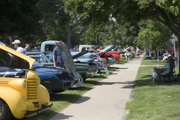 Classic cars on display as they line the Cultural Center campus on a sunny day.