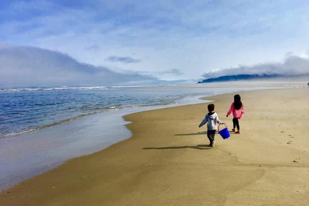 Kids on the beach with bucket
