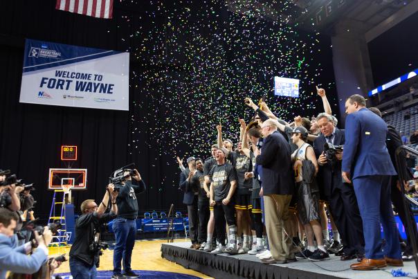 University of Wisconsin Oshkosh men's basketball team celebrating with confetti and the division 3 mens basketball trophy after winning the 2019 championship
