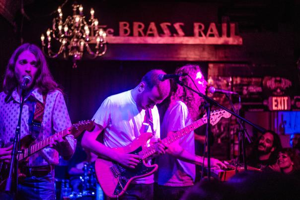 Band playing in dark lighting at the Brass Rail