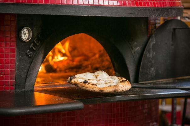 Pizza coming out of the wood fire oven at Pistarro's