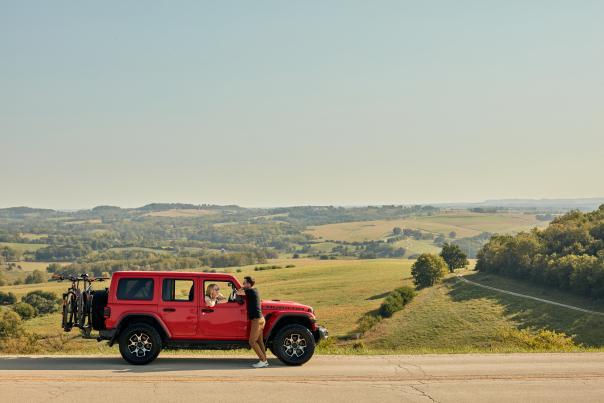 A couple with a red Jeep parked at the scenic overlook outside of Elizabeth, IL.