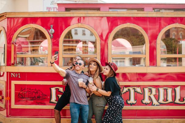 Group of friends taking selfie in front of Galena Trolley Tours