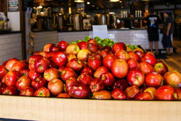 Red apples piled in a brown crate
