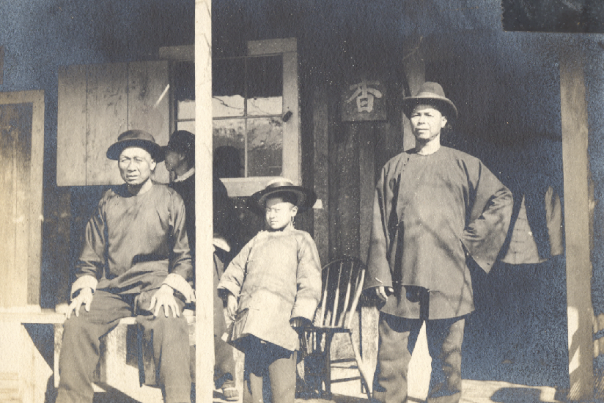 Photo of three men & child on porch.  c 1898.  Chinese New Year.