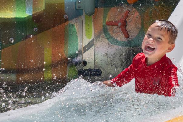 Boy going down water slide