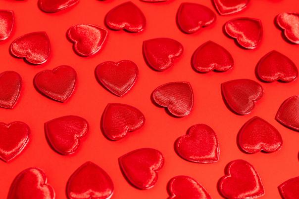 random red hearts on red background