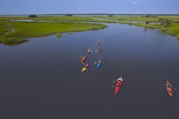 A group of kayakers paddle through the marsh in Golden Isles, Georgia