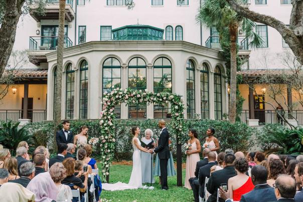 A bride and groom get married under the oaks at The Cloister on Sea Island, GA