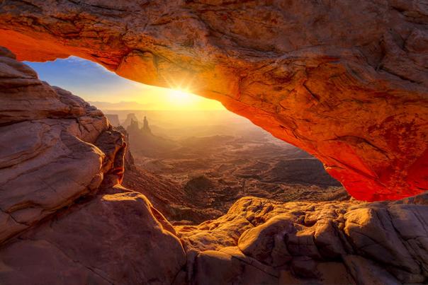 A fiery sunrise at the iconic Mesa Arch in Canyonlands National Park, Utah.