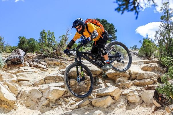 Picture of Guy Riding Mountain Bike Over Rocks Downhill