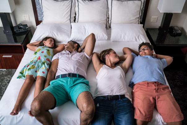 Family on hotel bed