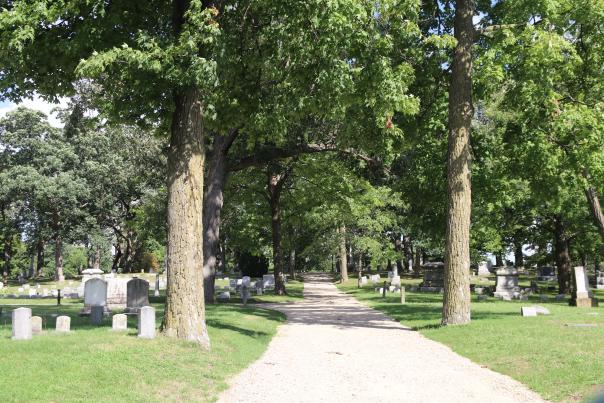 Walking path through trees in an historic cemetery in Grand Rapids