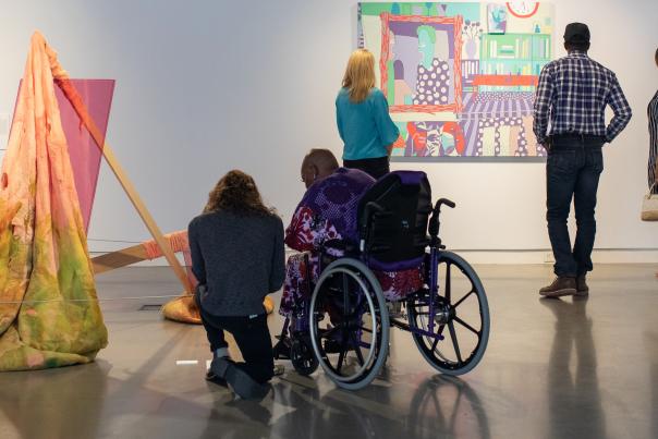 Group exploring art at UICA, one visitor in a wheelchair.