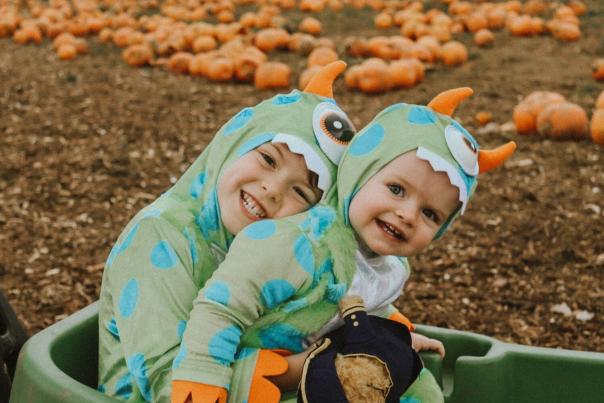Children in fancy dress in pumpkin patch
