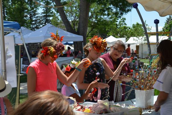 Attendees at the Arts Picnic making crafts at the creation station.