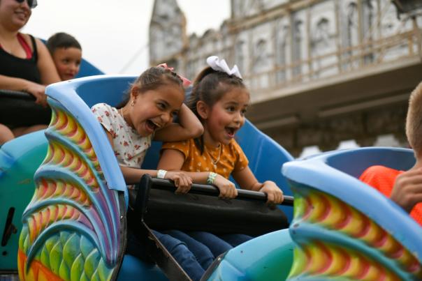 Two girls riding a carnival ride at the Greeley Stampede