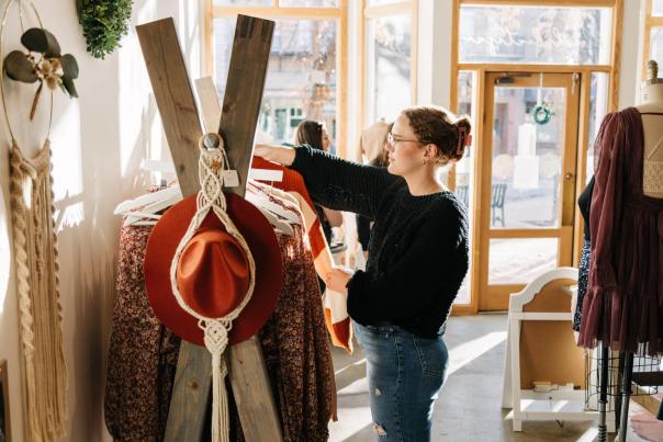 Woman looks through a clothing rack at Blush Boutique Co. in Downtown Greeley, Colorado