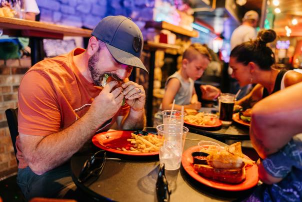 Dad eating a burger with his family at a restaurant in Greeley