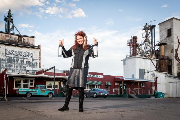 Heather Bean posing outside of Syntax Spirits Distillery & Cocktail Bar in Greeley, CO