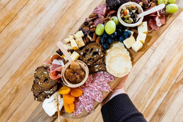 Cheese board with meats, cheese, and veggies