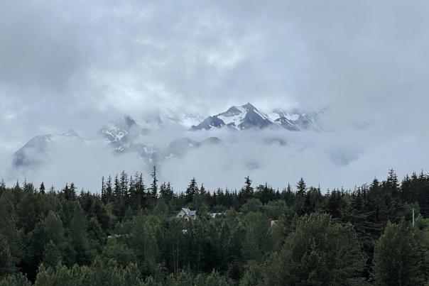 The mountain peaking through the clouds looking from the Carnival Luminosa