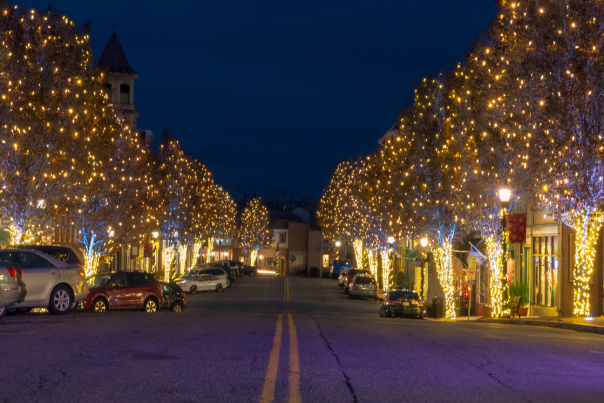 Main Street with trees decorated in gold christmas lights