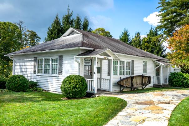 The small, white Highlands Historical Society Building.