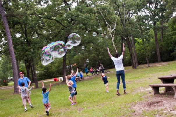 People Blowing Bubbles At The Bayou City Arts Festival