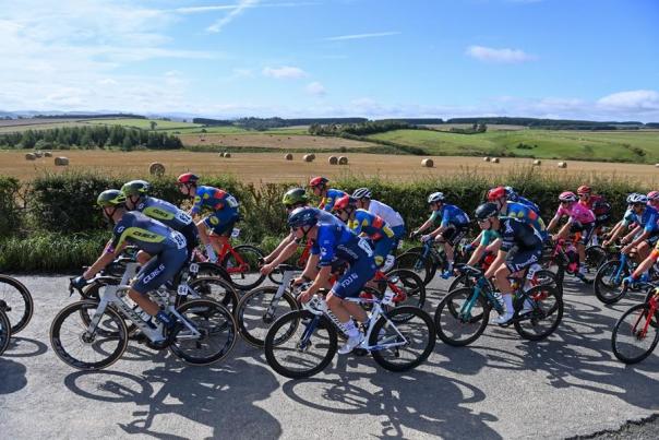 Tour of britain peloton rides past rolling hills and fields