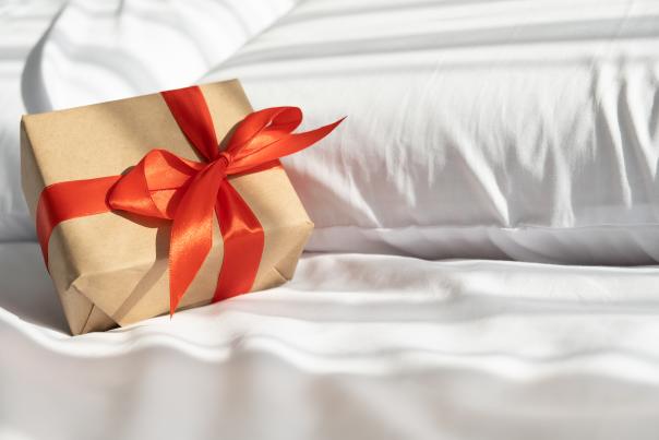 Gift on bed - Shutterstock