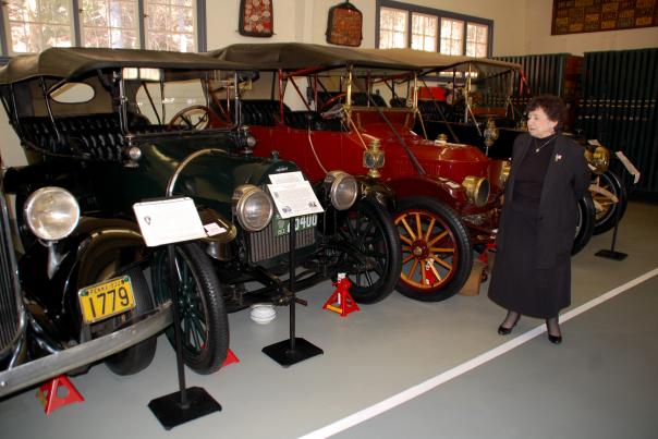 The late Pat Swigart, former President of the William E. Swigart Antique Automobile Museum, stands in front of the antique cars on display at the museum