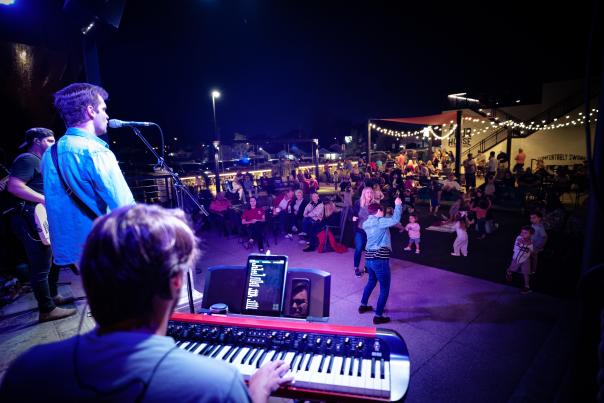 Musicians on a stage in the dark at Stovehouse